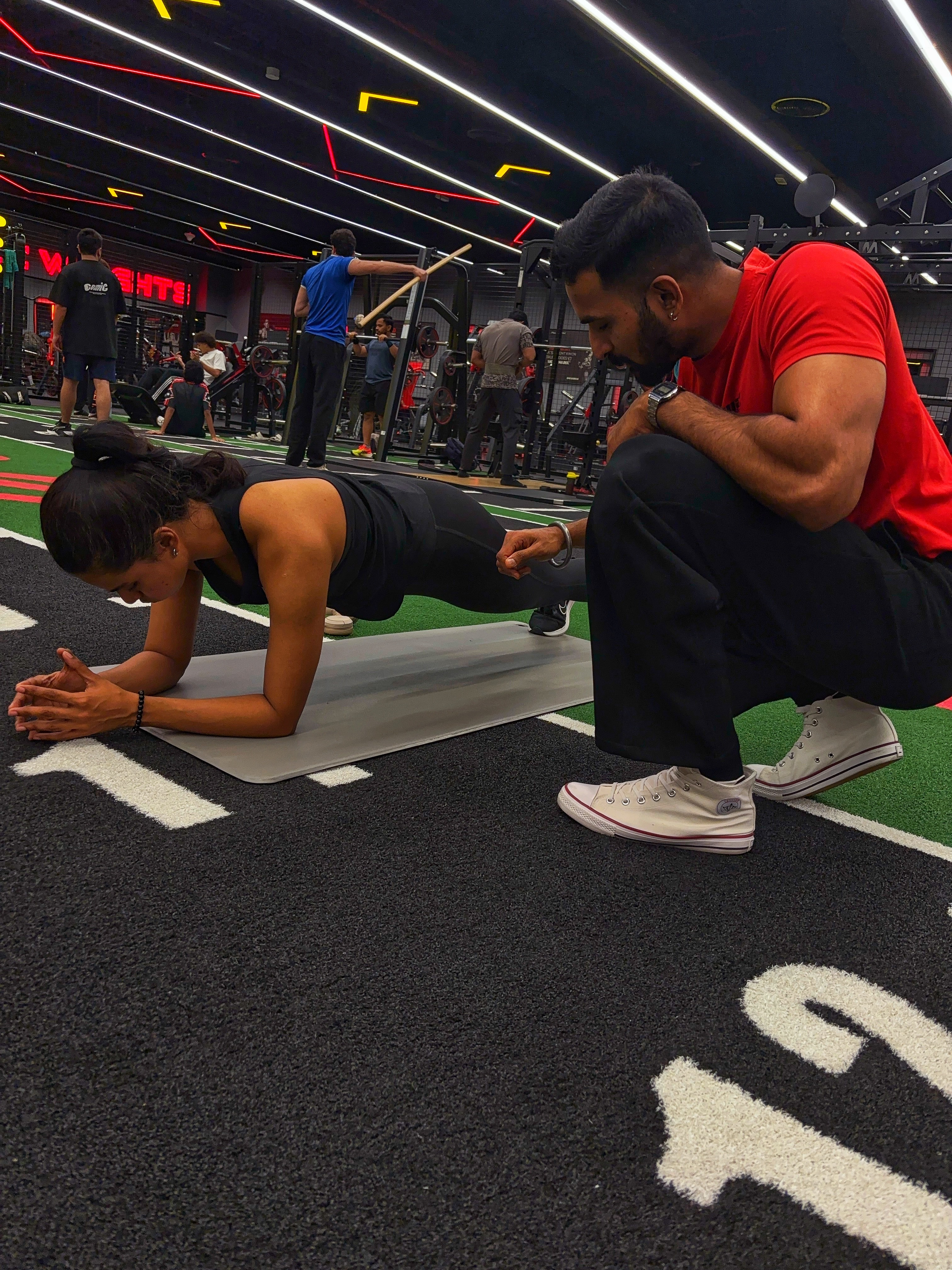 Client training with a personal coach in a modern gym